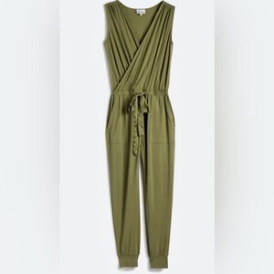 Flattering olive green jumpsuit, satin belt, pockets, laundered but never worn.
